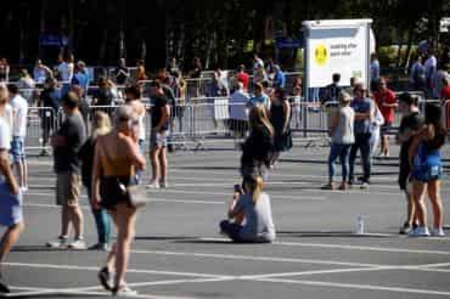 Keep your distance: people queue for school and IKEA in England