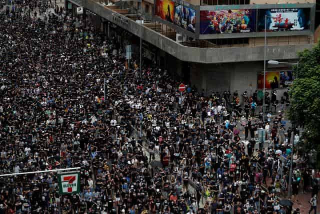 Protesters march in Hong Kong as rival rally supports police