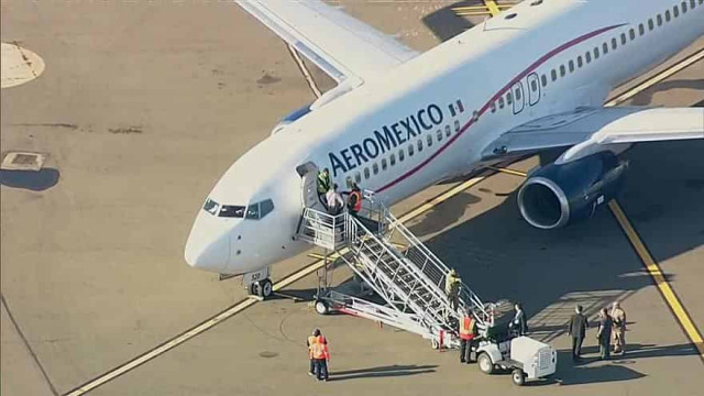 2 passengers arrested after threatening to open jet's doors on delayed flight
