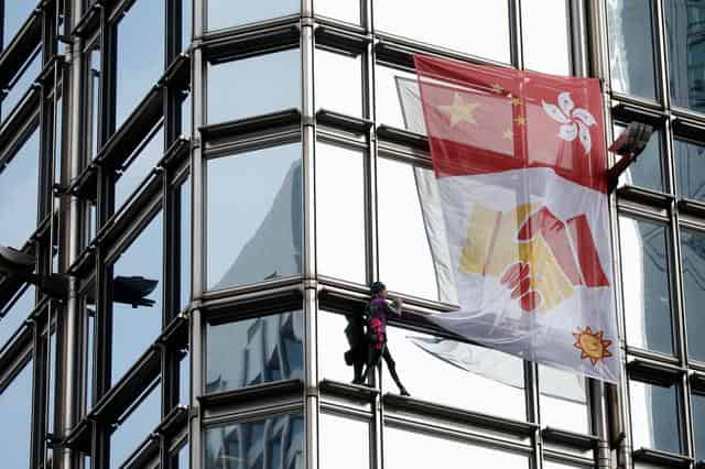 French 'spiderman' climbs HK tower, hoists reconciliation flag amid mass protests