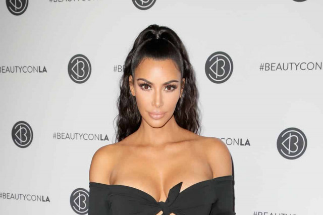 Kim Kardashian does hand stand to advertise her clothing brand (PHOTOS)