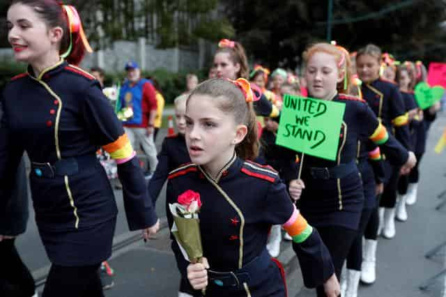 New Zealand reopens mosques that were attacked; many 'march for love'